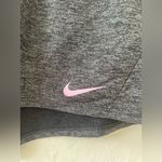 Nike gray women’s dri-fit athletic shorts with pink swoosh detailing; size XL Photo 1