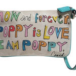Coach  Poppy Woodmark Multicolor Text Wristlet with Teal Accents. Photo 0