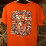 B. Jaxx Women’s Orange/Black Peace Love Football Tshirt Orange Size M Photo 0