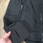 Women's Black running jacket with thumb holes. Photo 1