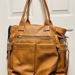 Brown patent leather diaper bag with multiple pockets and key holders Photo 0