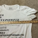 FIGS  White I AM AN OCCUPATIONAL THERAPIST Multilingual Graphic Tee Shirt Size S Photo 4