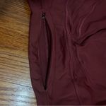 Lululemon 7/8 cropped leggings in a reddish color a bit warmer than maroon. Photo 3