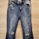 {29} KanCan Distressed Blue Jean Split Flare Hem Fringe Detail Photo 2