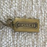 Coach  Brass Collectible Gold-Tone Logo Keychain Photo 1