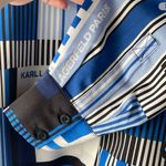 Karl Lagerfeld NWT  Paris Geometric Logo Blouse button up Long Sleeve shirt Blue choose your size msrp $89 All size available  New with tag  Same day shipping  Smoke and pets free  Add a luxurious touch to your wardrobe with this  Paris Geometric Logo Blouse button up Long Sleeve shirt. The shirt features a stylish geometric pattern in blue, black, and white colors, perfect for any occasion. It comes in sizes S/M/L/XL and is made of lightweight, breathable polyester that makes it suitable for all seasons. Super silky flowy.   The shirt's oversized design and packable feature make it a perfect addition to your fashions. The shirt is a part of the Paris Theme and has long sleeves, ideal for the colder months. The shirt is suitable for any size and does not compromise on quality. Photo 5