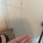 gold nike necklace Photo 0