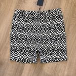 Mario Serrani Stylish bermuda shorts with a bold geometric design. Perfect for casual wear. NWT   Brand:  Italy • Material: A comfortable stretch blend, 76% rayon, 21% nylon, and 3% spandex. • Design: Feature a built-in tummy control panel for a flattering fit, front side seam slanted pockets, a zipper fly with a hook-and-bar closure, and faux back pockets. • Inseam: 9-inch inseam. - Length 18 inches  • Pattern: The shorts  feature a distinct black and white geometric or diamond print. Photo 1