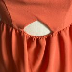 BCB GENERATION-SUMMER DRESS WITH CUTOUT-SIZE 2 Beautiful orange rust color dress, elastic waist, front cutout, back zipper, 100% polyester, excellent condition Measurements: Bust: armpit to armpit 16 inches Waist: side to side 14 inches Length: shoulder seam to bottom 32 inches Photo 1
