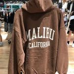 Brandy Melville  brown zip up sweater with graphic letters on the back Photo 0