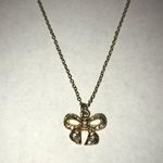 Gold bedazzled bow necklace Photo 1