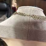 Very cute charm necklace. It has a cross with black in the middle. Photo 1