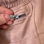 Free People movement dusty rose colored joggers with ankle zip and drawstring Photo 7