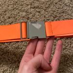 orange buckle belt Photo 0