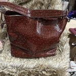 Pat leather, beautiful bag it’s a rich brown with little nobbies on it. Photo 1