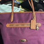 Coach Sawyer tote bag in a plum with leather accents and gold hardware Photo 0