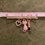 Charming Gold Hair Clip with Pink and Black Charms Photo 1