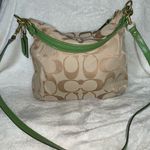 Coach  hobo-style crossbody purse, beige signature with green leather trim. Photo 3