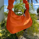 Vibrant Orange Crescent Shoulder Bag with Compact Design Photo 1