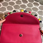 Pink Pebbled Clutch with Playful Tassel Pom Pom Trim Photo 3