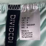 Divided H&M -MAXI SKIRT-SIZE 4 Gorgeous mint green skirt, mini skirt with a sheer maxi overlay, elastic waist, slits on both sides of the skirt, excellent condition Measurements: Waist: side to side 13-17 inches Length: mini skirt Waistband to bottom 13 inches Length: overlay skirt Waistband to bottom 41 1/2 inches Photo 7