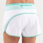 Lululemon Size 6 Turbo Running Short in white with a mint green waistband Photo 1