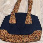 BLUE DENIM HANDBAG WITH FLORAL CORKLIKE DESIGN ON BOTTOM & HANDLES RED INTERIOR Photo 0