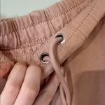 Free People movement dusty rose colored joggers with ankle zip and drawstring Photo 12