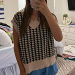 tan and black sweater vest Photo 1
