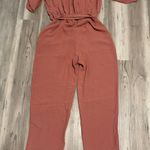 Maronie Jumpsuit Size Large, with tie belt and front chest closure,Mauve, Pit to pit is 22, length from shoulder to foot is 54, stretch waist, adjustable sleeve Photo 1