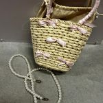 Elegant Straw Tote with Pink Bow Accents Photo 2