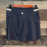 Athleta Ace Black Tennis Skort with silver reflective stripe on waistband Photo 6