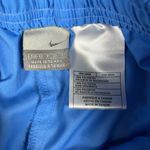 Nike Vintage Cropped Blue Pants with Orange and White Stripes
Size: small Photo 2