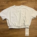 Lululemon Softstreme Gathered T-Shirt  Peach-fuzz soft texture Feels smooth next to skin Four-way stretch Quick-drying Weighty drape Machine washable. Water drops can easily mark this fabric—a simple wash will remove them  ColourLight Vapor Photo 2