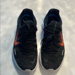 Nike Black Athletic Shoes with orange, blue and purple back Photo 1