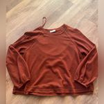 Brand New In Burnt Orange Top. Size medium. Photo 0