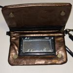 GiGi HILL BRONZE COLORED CROSSBODY OR WRISTLET
HAS BOTH STRAPS
VEGAN LEATHER Brown Photo 3