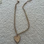 Vintage gold heart shaped necklace with evil eye detail and red stone in center Photo 1