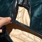 Coach  Black Leather Flats with Gold Emblem Photo 2