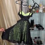 Bebe Black and lime green sheer dress with cutout sides Photo 1