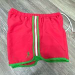 Adidas Women's Vibrant Red Athletic Shorts with Green Trim are a size Large. Photo 12