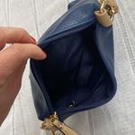 Charming Charlie small blue crossbody bag with tan strap. Photo 3