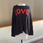 Wooden Ships  Charcoal blue Knit sweater with orange colored letters reading Love Photo 1
