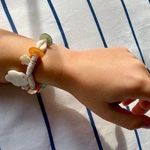 painted seashell and puka shell bracelet with charms Photo 0