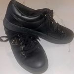 Guess Beautiful black and gold flat tennis shoes size 9 with gold triangle logo Photo 0