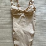SKIMS Seamless Sculpt Thong Bodysuit in “Sand” Photo 0