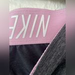 Nike gray women’s dri-fit athletic shorts with pink swoosh detailing; size XL Photo 3