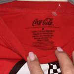 Coca-Cola  RED LONG SLEEVE TEE SHIRT
WITH GRAPHIC DESIGN ON FRONT SIZE MEDIUM Photo 4