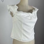 About Us  White Ruffle Crop Blouse Photo 1