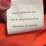 Grey's Anatomy V-Neck Short Sleeve scrub Top in Coral/orangish. Size Medium. Photo 12